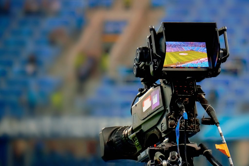Professional camera filming a soccer match